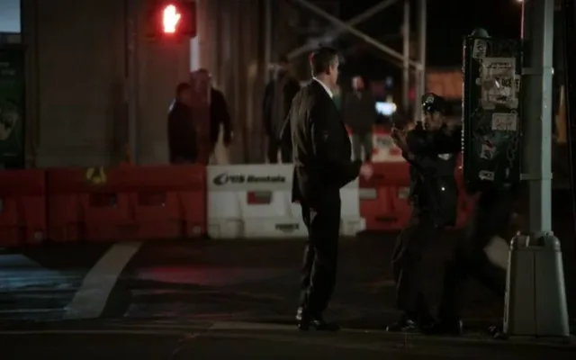 A still from Person of Interest: a man in a dark coat on a city street at night