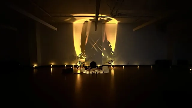 Crystal bowls and candlelight before a wall of leaf shadows