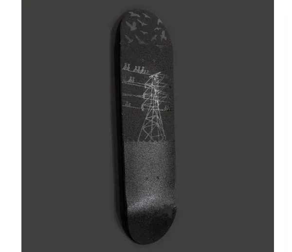 A black skateboard deck with a gray electricity pylon