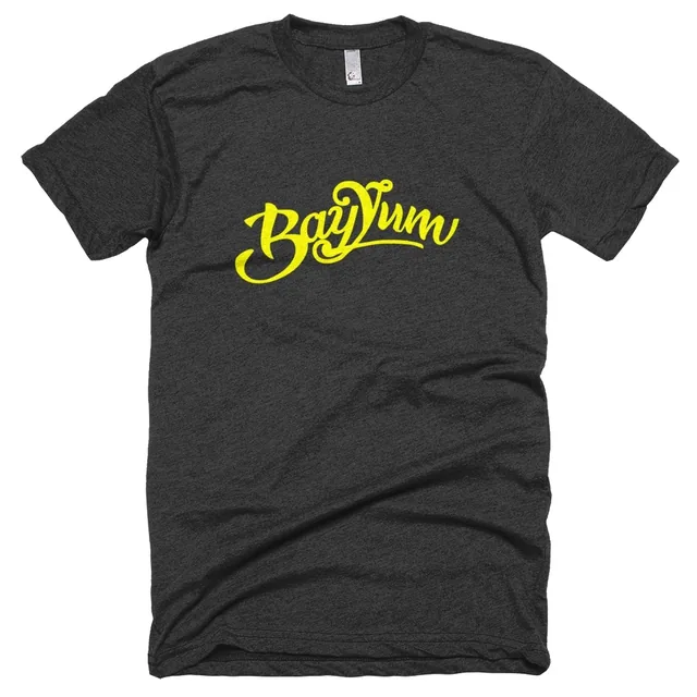 The same T-shirt in heather black, the yellow BayYum script across the chest