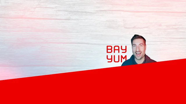 Another version of the channel art on bleached, almost white wood, with BAY YUM in red beside the same cut-out of Graham, above the red band
