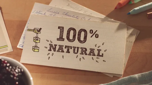 A handwritten recipe card overlaid with 100% NATURAL in drawn letters, beside a small drawn machine