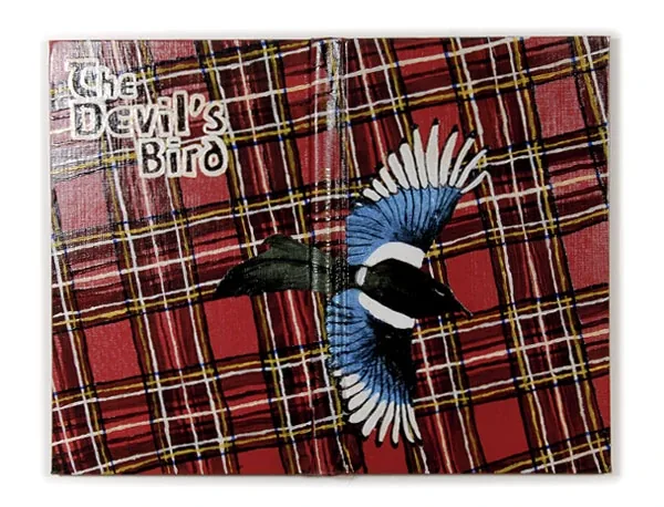 A magpie in flight over red tartan, titled The Devil’s Bird