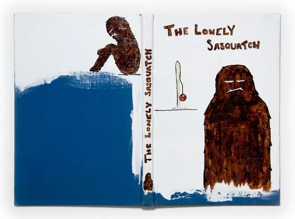 A brown sasquatch beside blue water, titled The Lonely Sasquatch