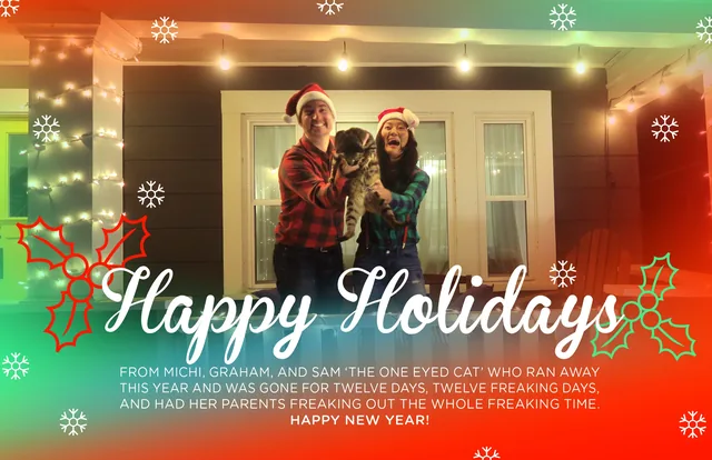 Graham and his wife in Santa hats on a porch with their cat under string lights, Happy Holidays in red script