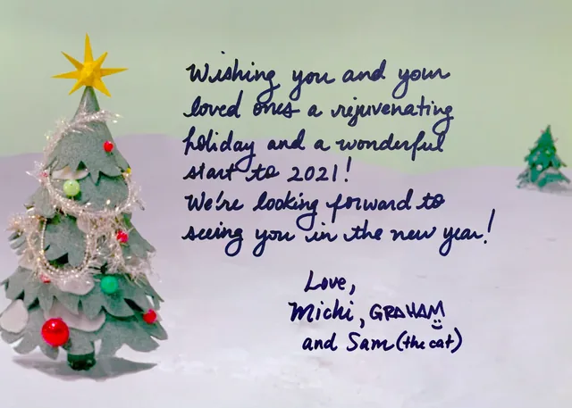 A handwritten note beside a tinsel Christmas tree, wishing a rejuvenating holiday and a wonderful start to 2021