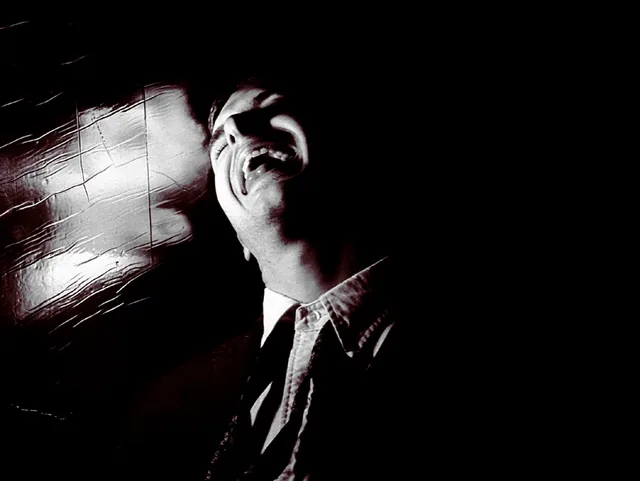 A figure in black and white, half lost in a streak of light