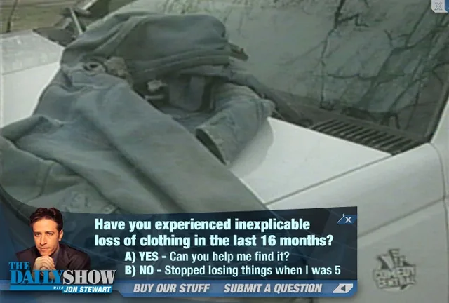 Over a shot of a jacket lying on the hood of a white car, a strip along the bottom with The Daily Show with Jon Stewart logo, Jon Stewart’s photo and a poll: Have you experienced inexplicable loss of clothing in the last 16 months? A) Yes, can you help me find it? B) No, stopped losing things when I was 5. Below it, Buy Our Stuff and Submit a Question