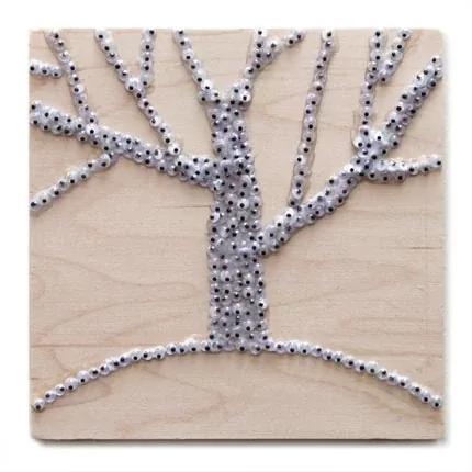 A six-inch square panel with one tree of googly eyes