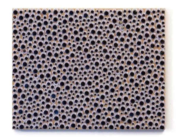 A panel covered edge to edge in googly eyes
