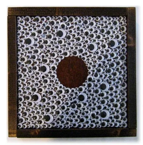 A frame filled with googly eyes around a single brown circle