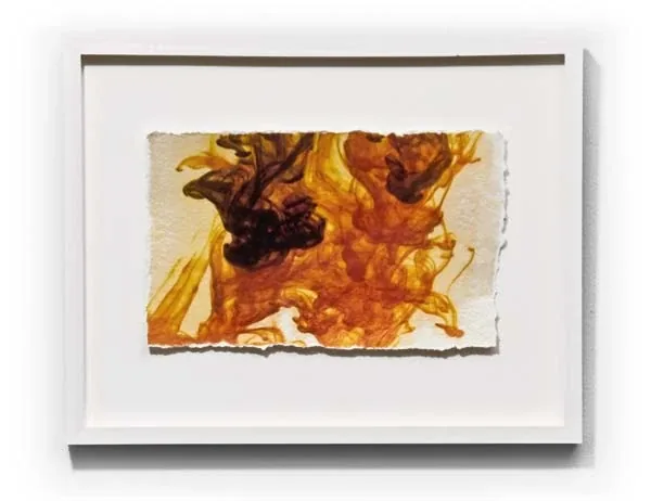 Orange and brown clouds on a deckled sheet, framed