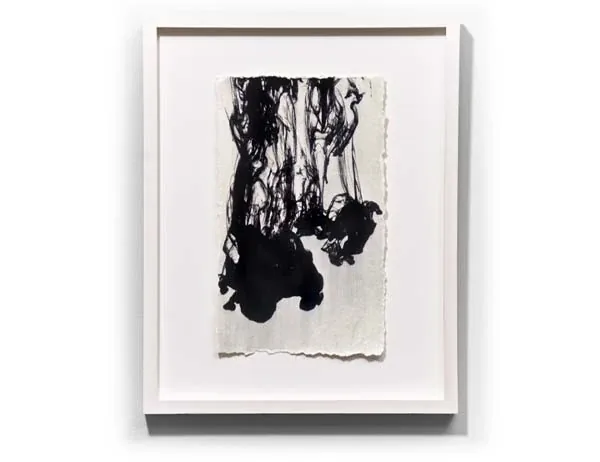 Black ink falling down a deckled sheet, framed