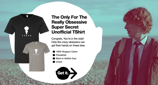 The shop page: a still from the film of a young man in a tie on a pebble beach, beside a white speech-bubble shape holding a black and a heather-gray T-shirt, the heading The Only For The Really Obsessive Super Secret Unofficial TShirt, a few lines of copy, four bullet points and a round black Get it. button with an arrow