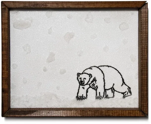 A polar bear walking through a field of white, in a dark wood frame