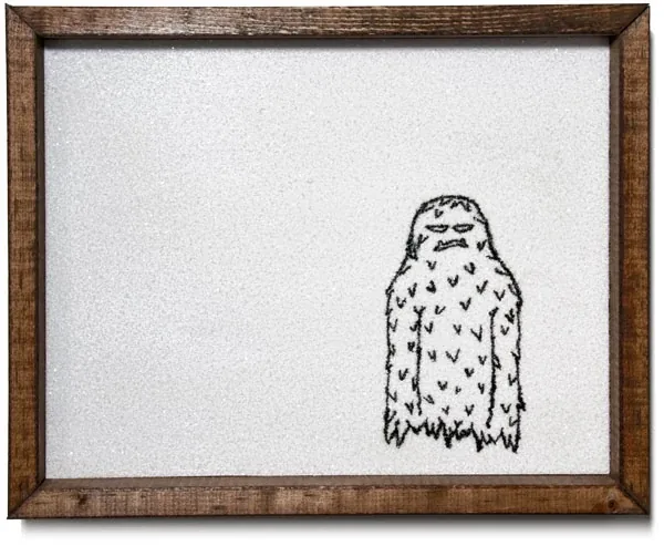 A furry yeti drawn small in a white field