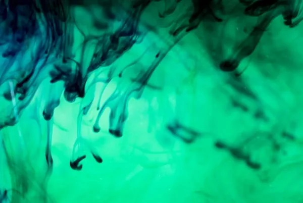 Teal ink curling through water