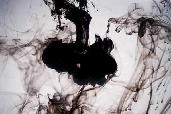 A cloud of black ink spreading through clear water