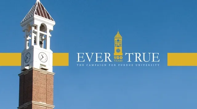 The Ever True logo beside Purdue’s clock tower on a gold band
