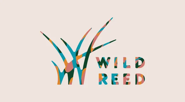 The Wild Reed Yoga logo on linen: reeds forming a W beside the words WILD REED, patterned in patches of teal, forest green, orange and pink