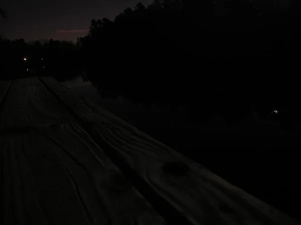 Weathered dock boards in near darkness