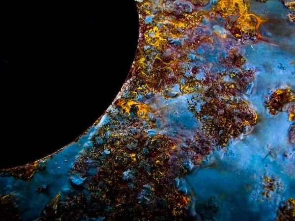 Blue and rust texture beside a black circle