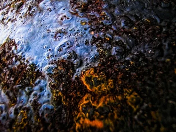 Pale blue crust over dark rust