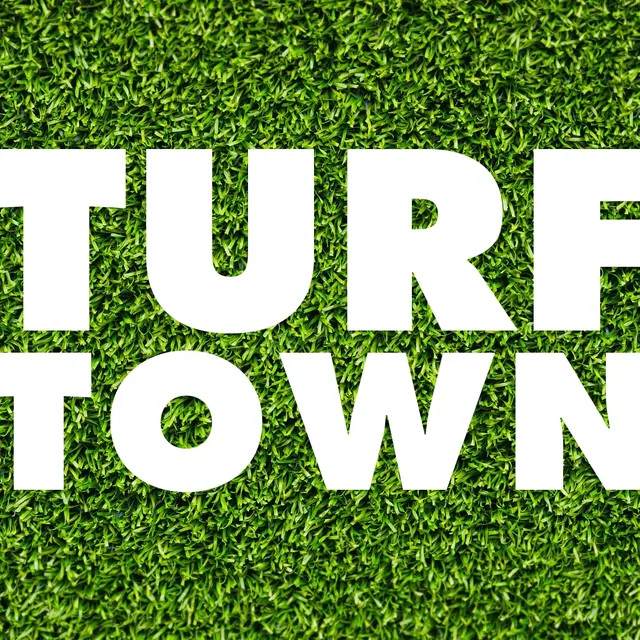 The Turf Town logo: TURF over TOWN in heavy white capitals across a square of bright green grass, the letters running off its edges