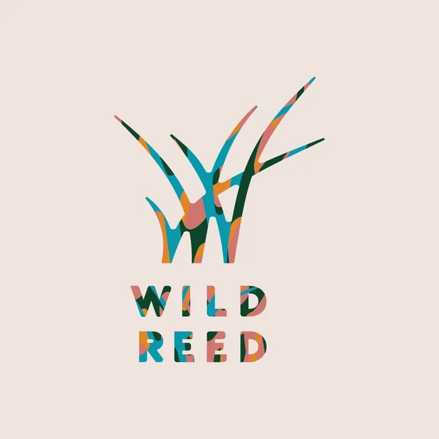 The Wild Reed logo on linen: reed strokes forming a W above the words WILD REED, all patterned in patches of teal, forest green, orange and pink
